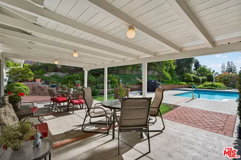 a building outdoor space with patio furniture and potted plants
