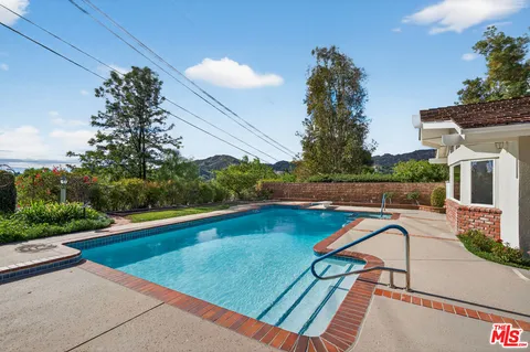 a view of swimming pool with seating space