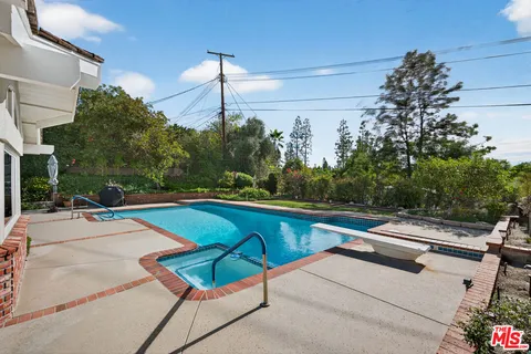 a view of a swimming pool with a patio