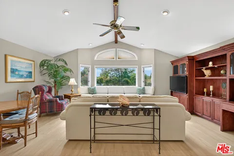a living room with furniture a window and a chandelier