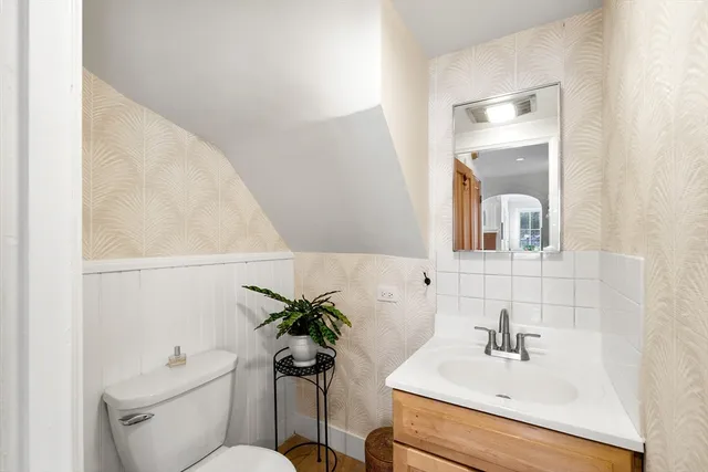 a bathroom with a sink toilet and mirror