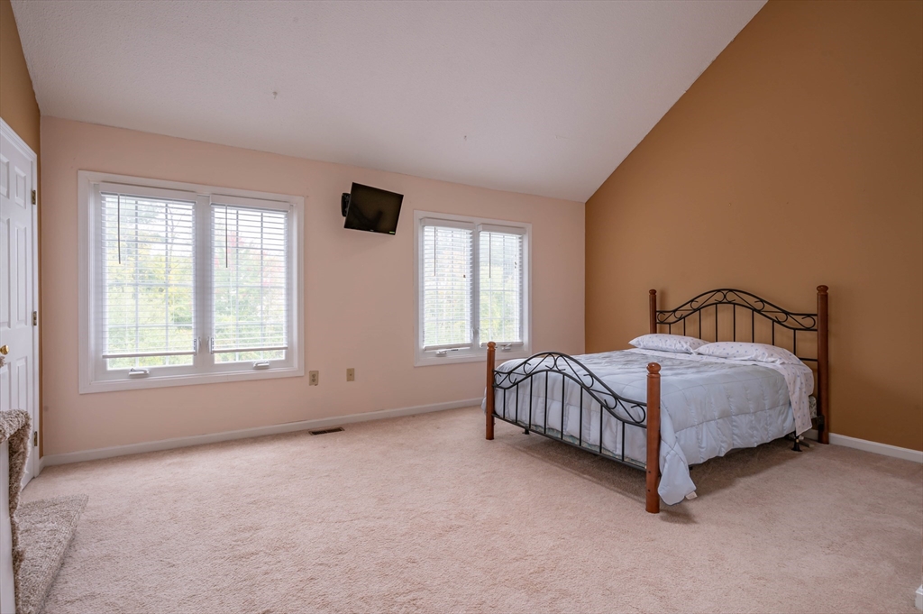 12 Perley Road, Unit 5 Derry, NH 03038 - Photo 13 of 21 a spacious bedroom with a bed and window