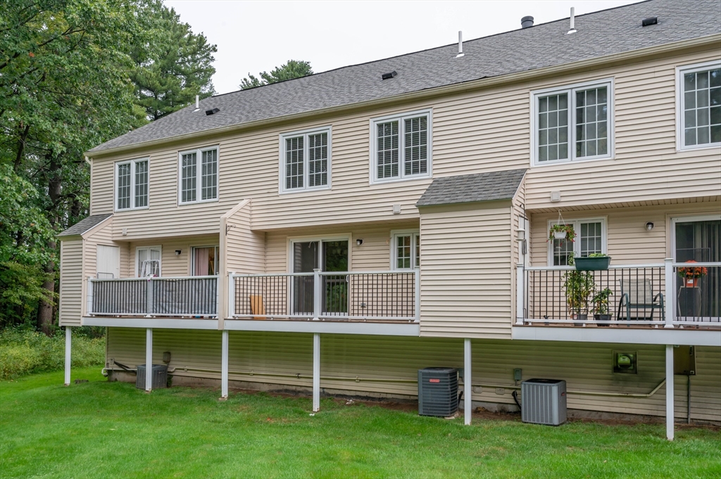 12 Perley Road, Unit 5 Derry, NH 03038 - Photo 20 of 21 a front view of a house with a yard