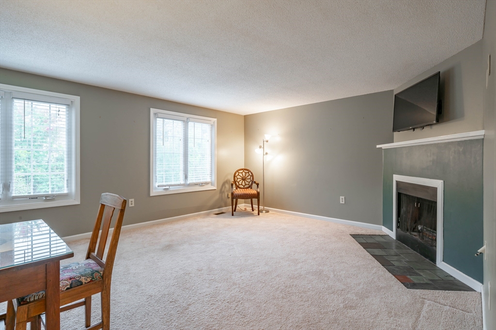 12 Perley Road, Unit 5 Derry, NH 03038 - Photo 7 of 21 a workspace with a fireplace and a window
