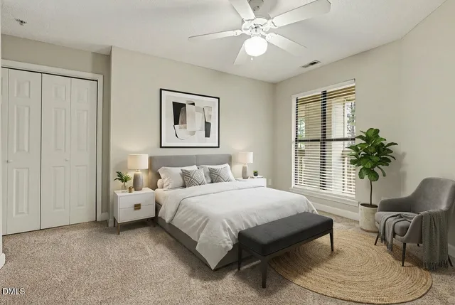 a bedroom with a large bed and a couch