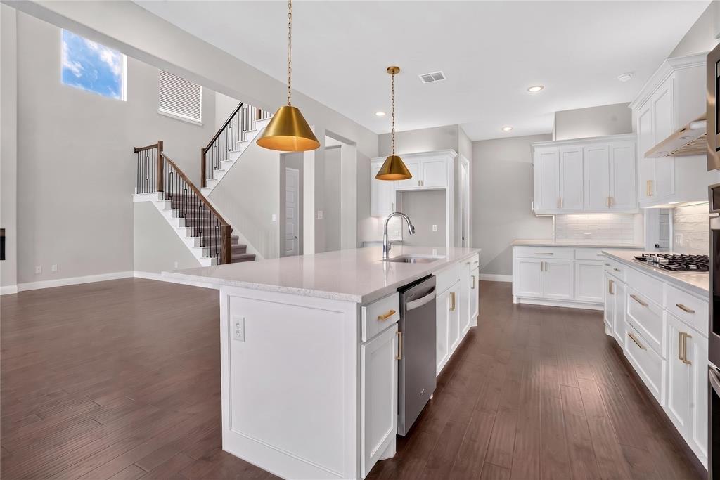 2528 Horsetail Road Frisco, TX 75033 - Photo 12 of 39 White crisp kitchen color of quarts, cabinets and backspalsh enhances the contemprary modern look to the open concept layout.