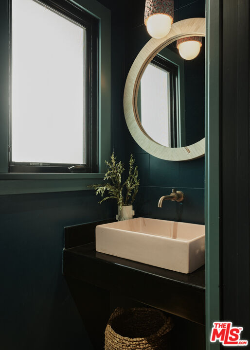 775 San Rafael Terrace Pasadena, CA 91105 - Photo 16 of 56 a bathroom with a sink and a mirror