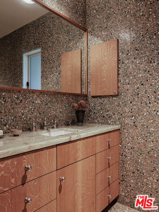 775 San Rafael Terrace Pasadena, CA 91105 - Photo 17 of 56 a bathroom with a sink and a mirror