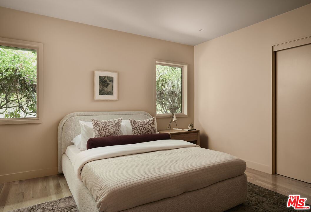 775 San Rafael Terrace Pasadena, CA 91105 - Photo 21 of 56 a bedroom with a bed and a window