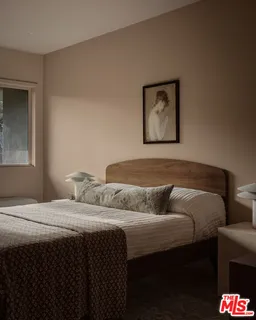 a bedroom with a bed and a mirror