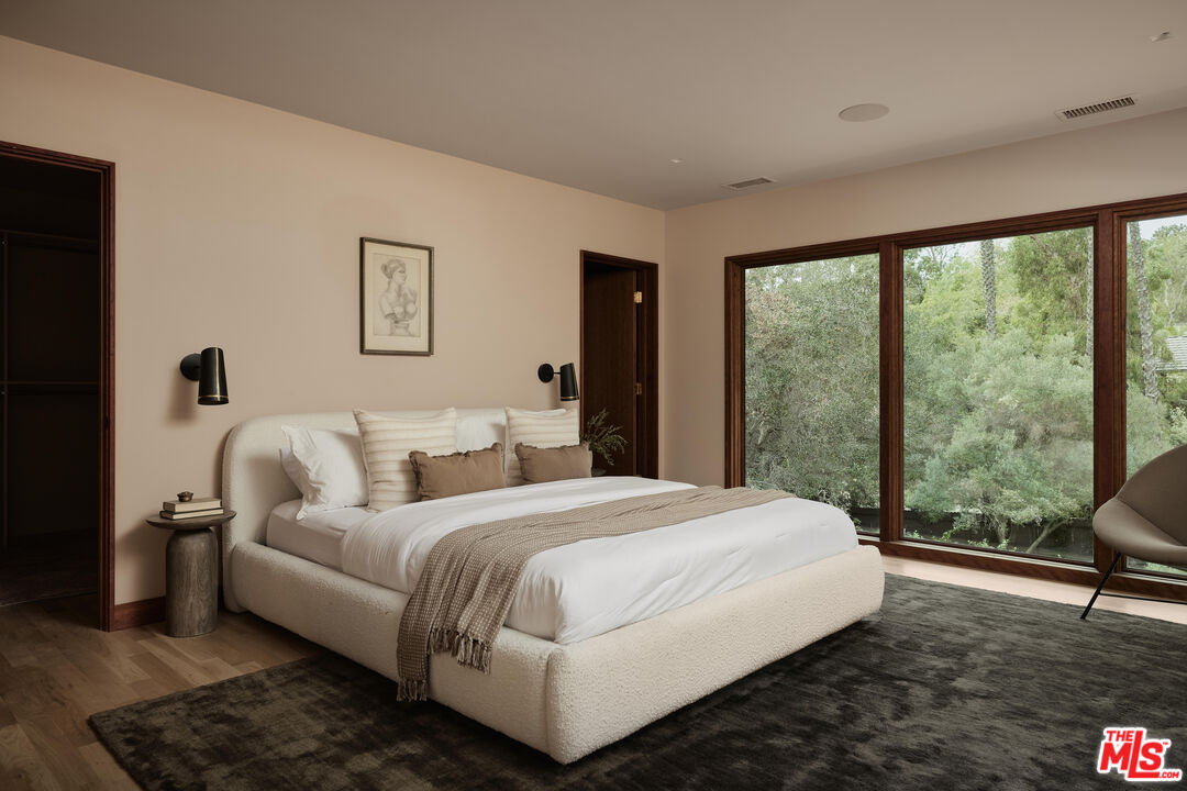 775 San Rafael Terrace Pasadena, CA 91105 - Photo 30 of 56 a bedroom with a bed and a large window