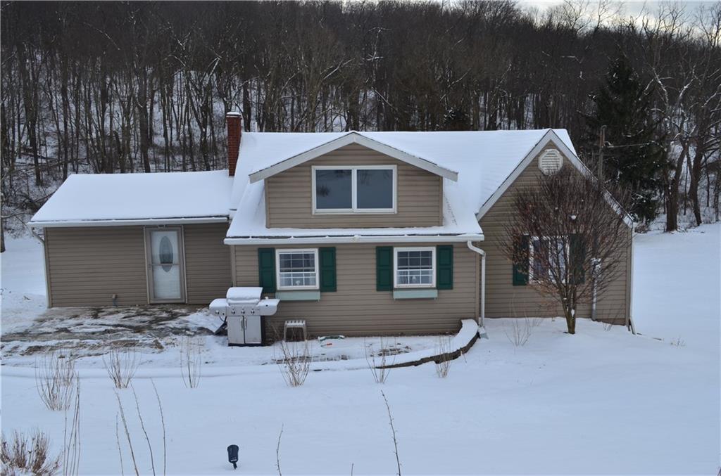 Front view of the home -- current owners park right by the door, however, it could be a patio area as well! 