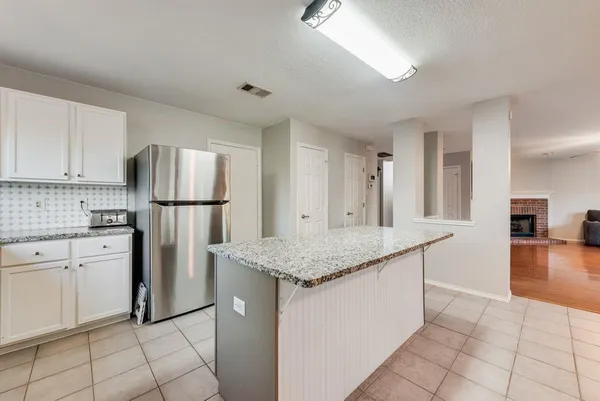 a kitchen with appliances cabinets and wooden floor