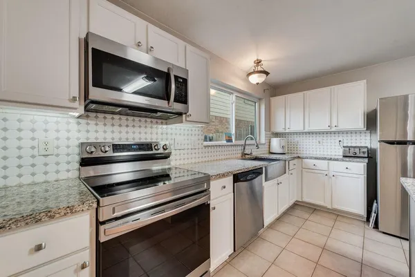 a kitchen with a stove and a microwave