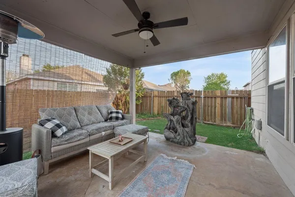 a living room with patio furniture and a wooden floor