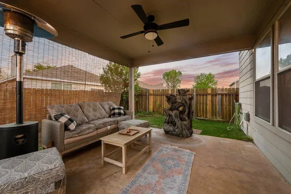 a living room with patio furniture and a wooden floor