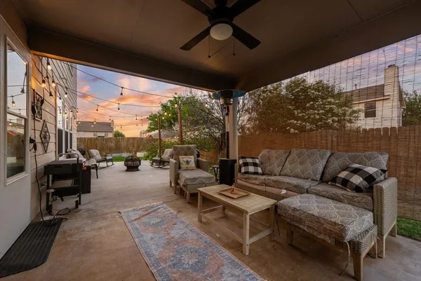 a living room with furniture and a floor to ceiling window