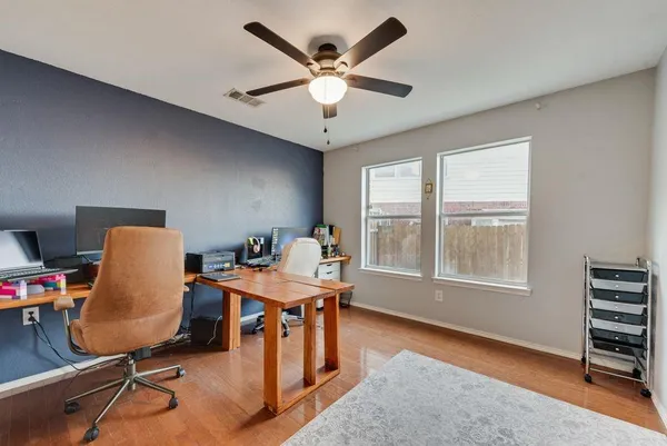 a workspace with furniture hardwood and a window