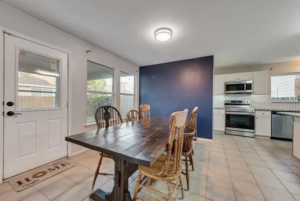a dining room with furniture and window