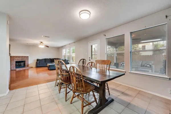 a dining room with furniture and a floor to ceiling window