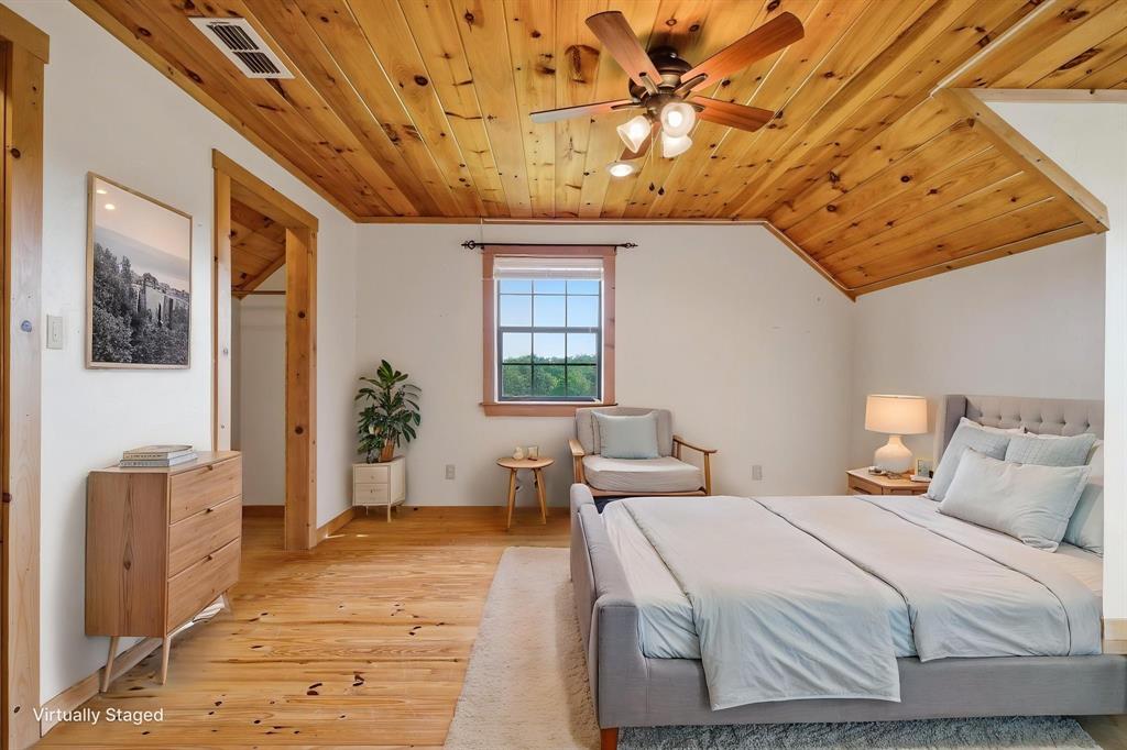 465 Emberson Ranch Road Pilot Point, TX 76258 - Photo 24 of 40 a bedroom with a bed and wooden floor
