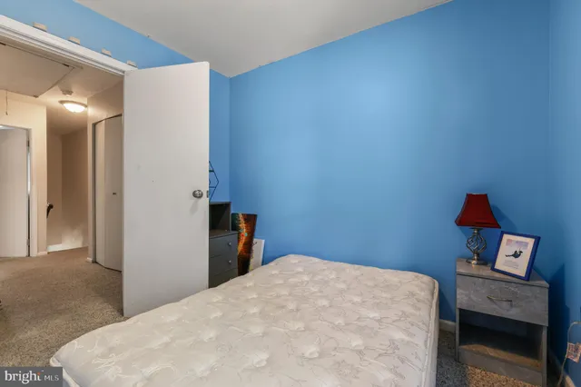 a bedroom with a bed and a dresser