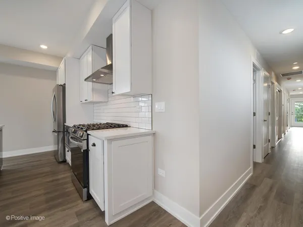 a kitchen with stainless steel appliances a stove and a refrigerator