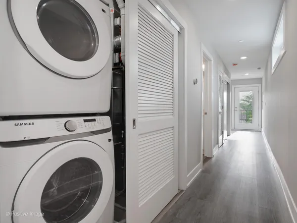 a view of a hallway with washer and dryer