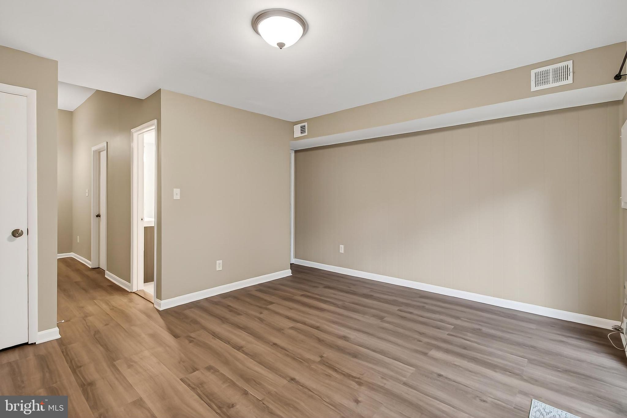5833 Royal Ridge Drive, Unit 943 Springfield, VA 22152 - Photo 34 of 45 a view of an empty room with wooden floor