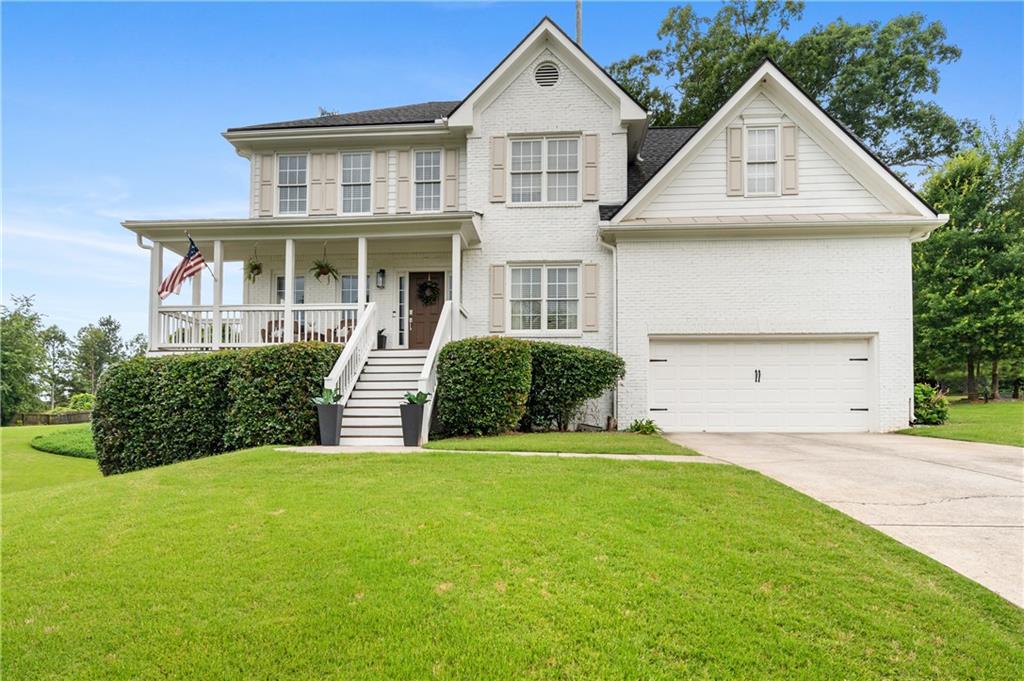 6430 Chip Shot Way Suwanee, GA 30024 - Photo 1 of 1 a front view of a house with a yard and garage