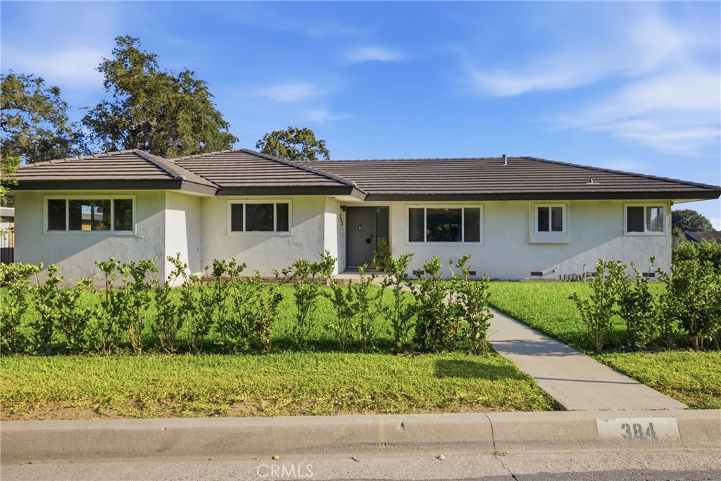 384 Colorado Street Arcadia, CA 91007 - Photo 9 of 51 a front view of a house with a garden