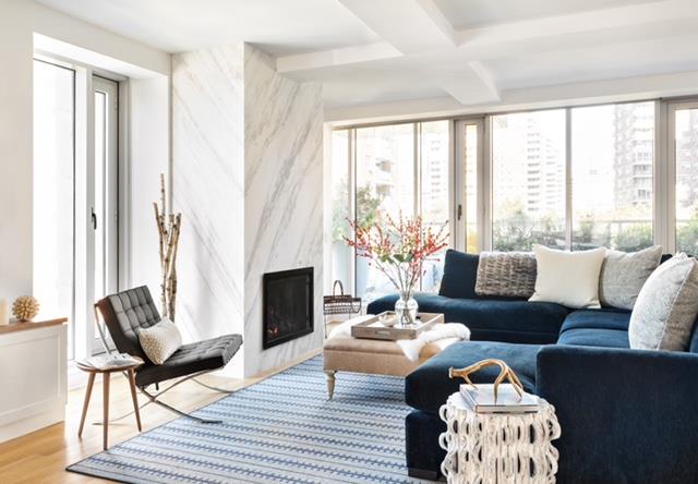a living room with furniture fireplace and a large window
