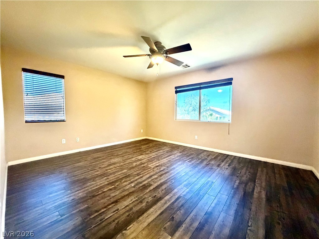 3936 Gold Point Street Las Vegas, NV 89129 - Photo 10 of 23 Hardwood-style flooring and overhead lighting enhance this adaptable living space.