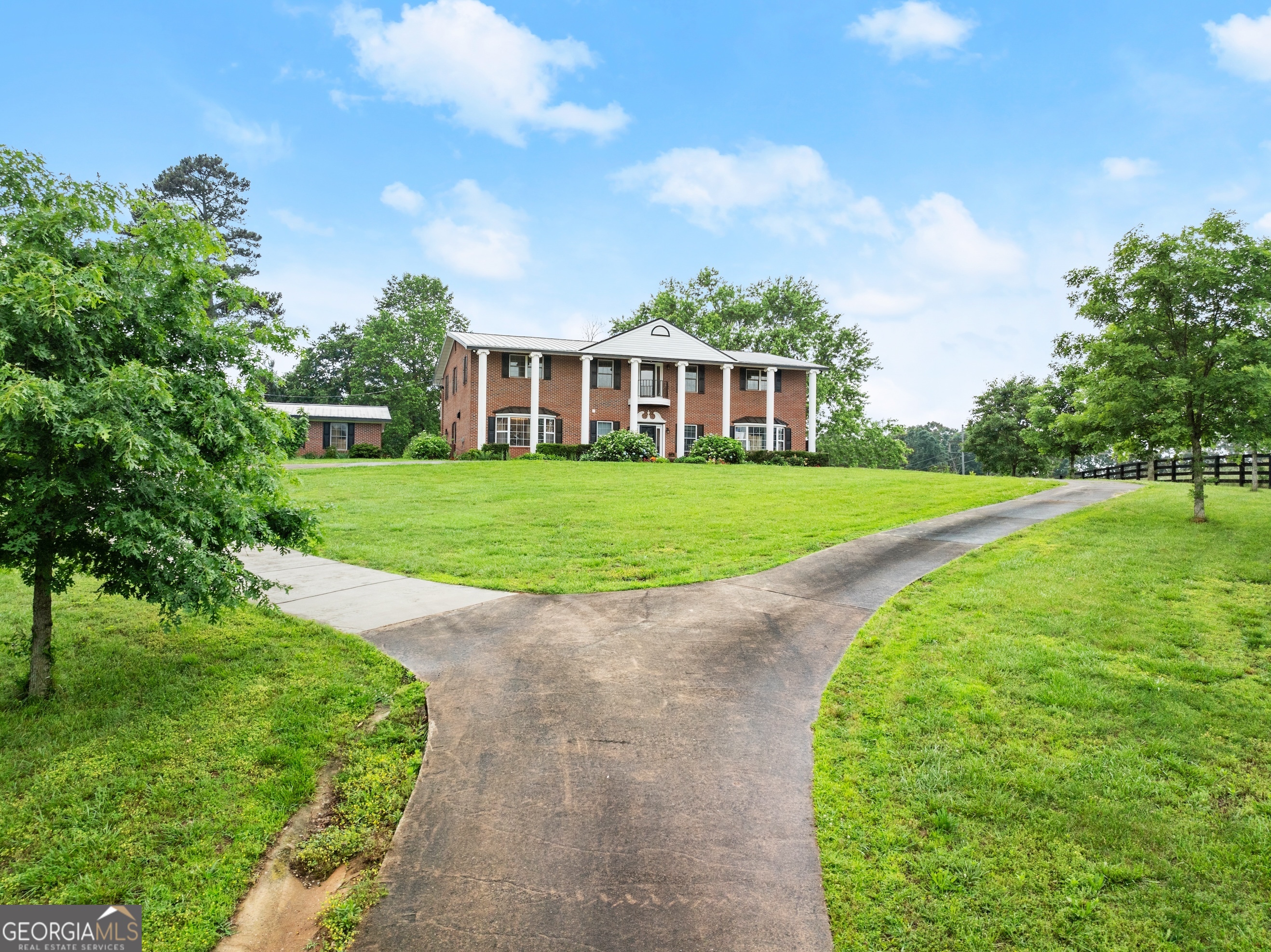 7215 Kelly Bridge Road Dawsonville, GA 30534 - Photo 78 of 81 a view of a big house with a big yard and palm trees