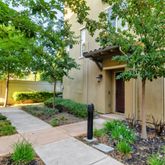 a front view of a house with a yard and lake view