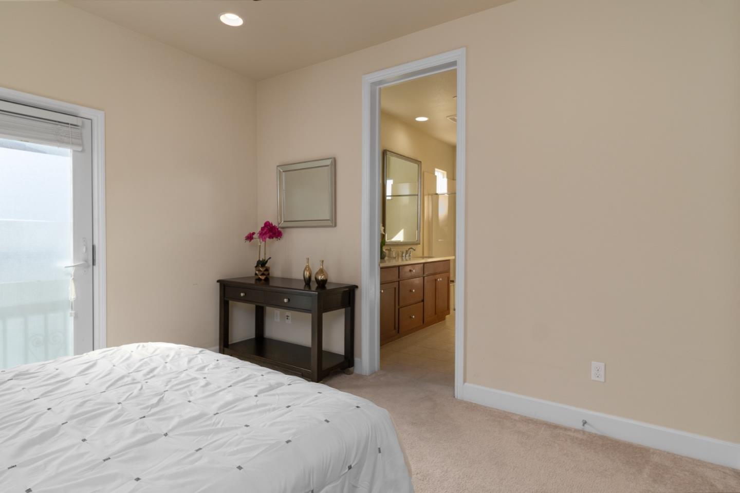 545 Holthouse Terrace Sunnyvale, CA 94087 - Photo 13 of 24 a bedroom with a bed and a table