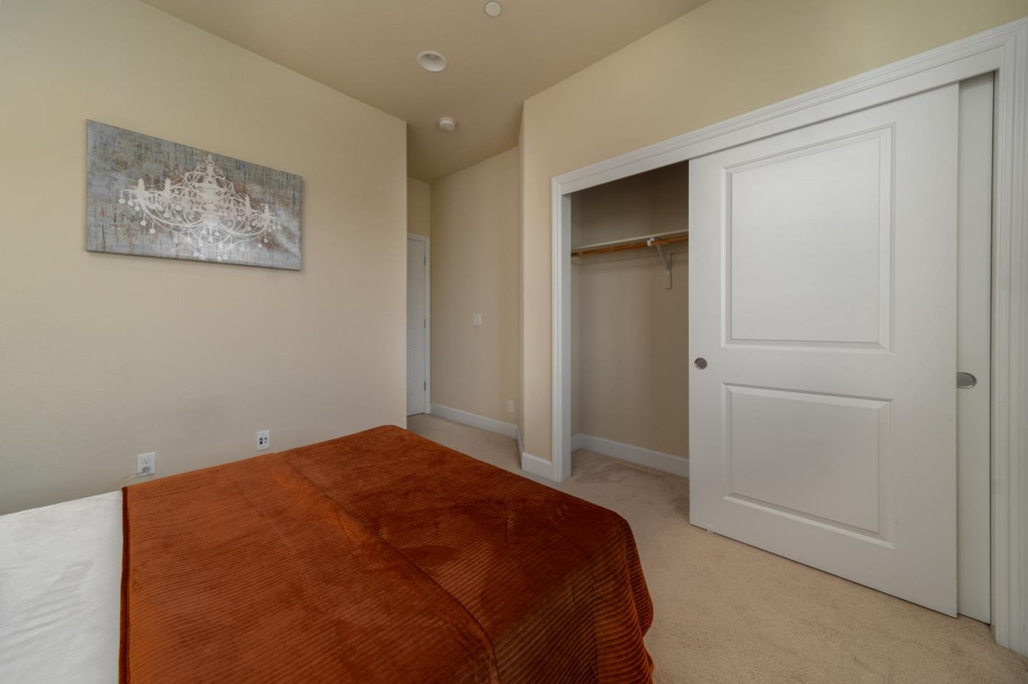 545 Holthouse Terrace Sunnyvale, CA 94087 - Photo 17 of 24 a bedroom with a bed and painting on the wall