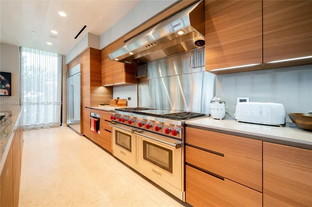 a kitchen with stainless steel appliances granite countertop a stove and a sink