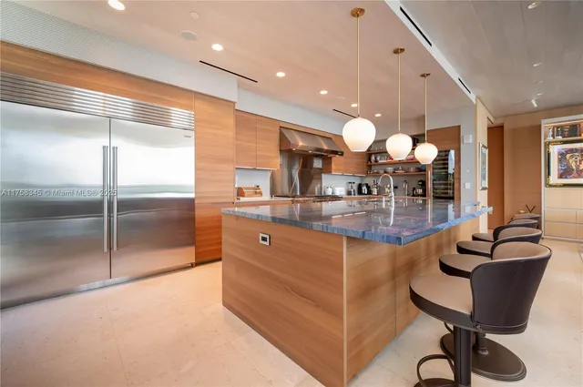 a kitchen with granite countertop a table and chairs in it