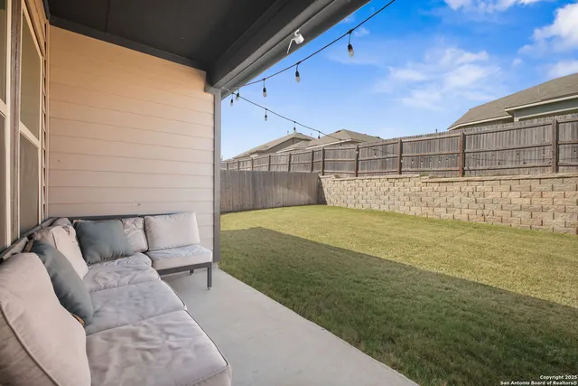 a view of a backyard with furniture