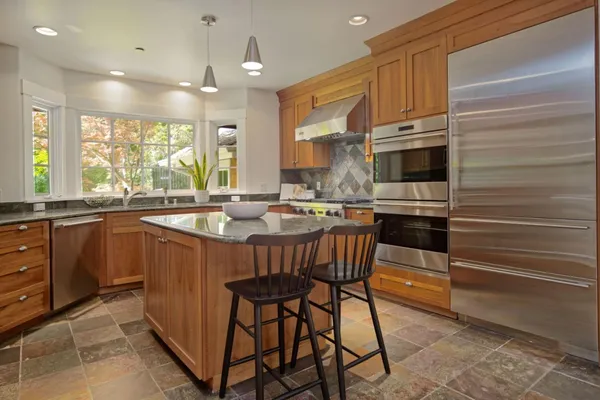 a view of a backyard with table and chairs and potted plants