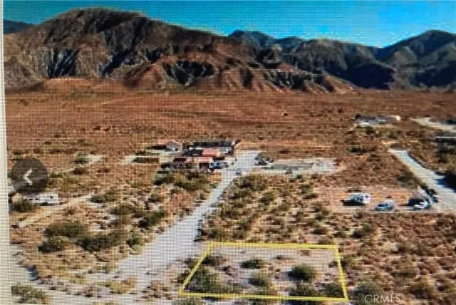 a view of a yard with wooden fence