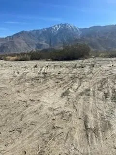 a view of mountain with sunset in background