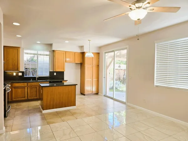 a large kitchen with kitchen island granite countertop a large counter top and stainless steel appliances