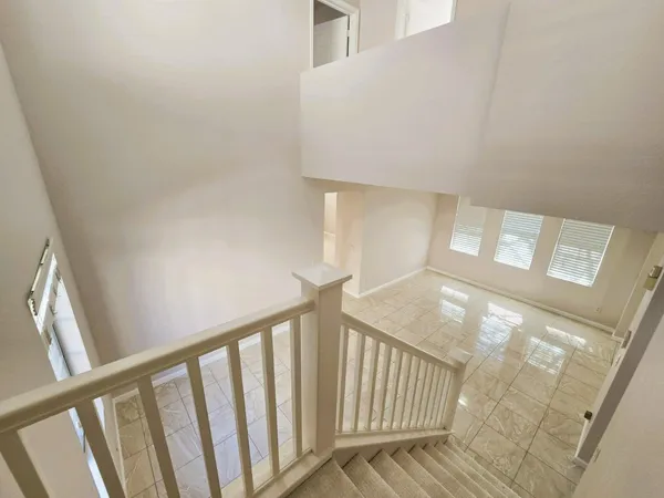 a view of staircase with rug
