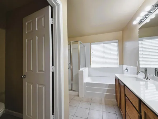 a bathroom with a tub sink and a mirror
