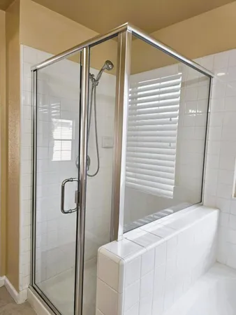 a bathroom with a bathtub and a shower