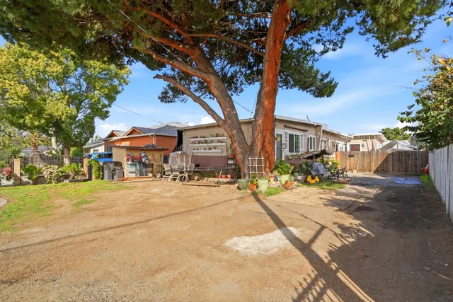 a street view with residential houses and trees