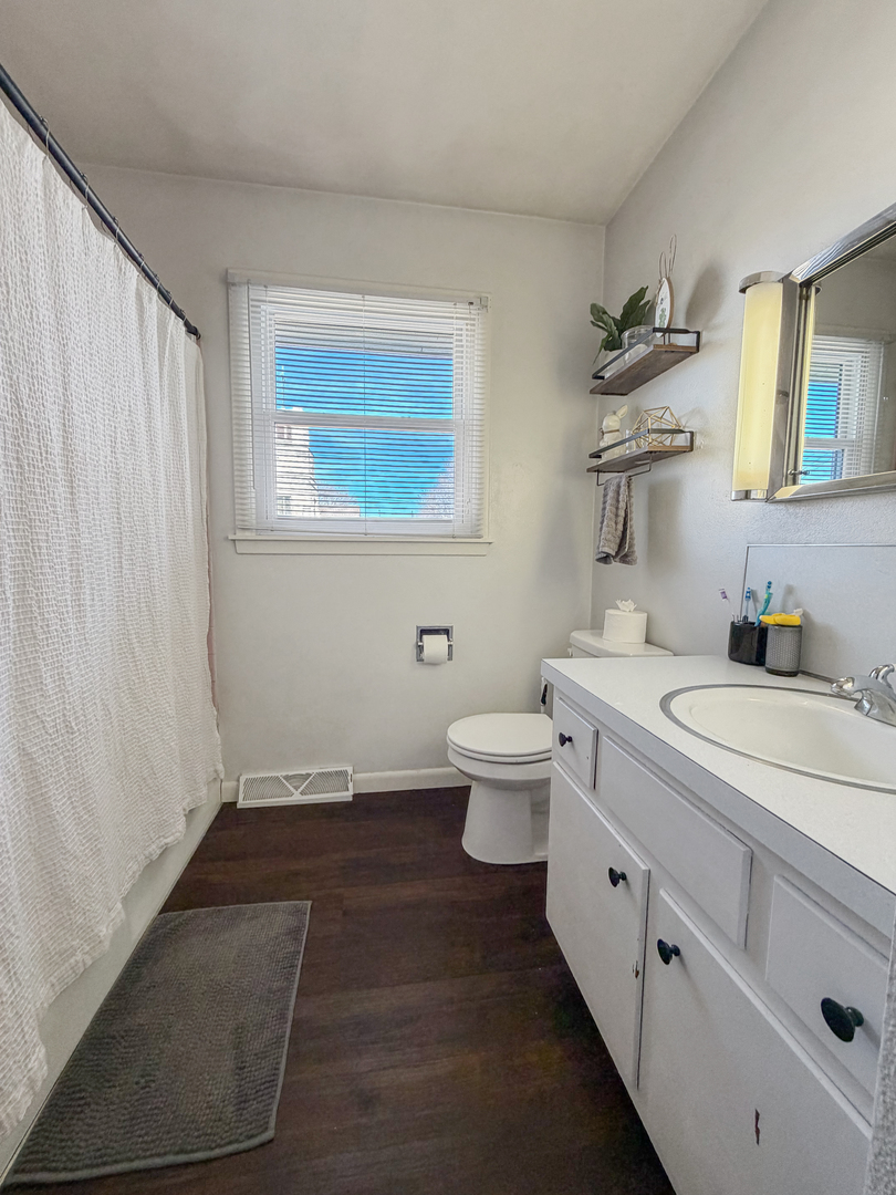 1506 South Walnut Avenue Freeport, IL 61032 - Photo 13 of 24 a bathroom with a granite countertop sink toilet and mirror
