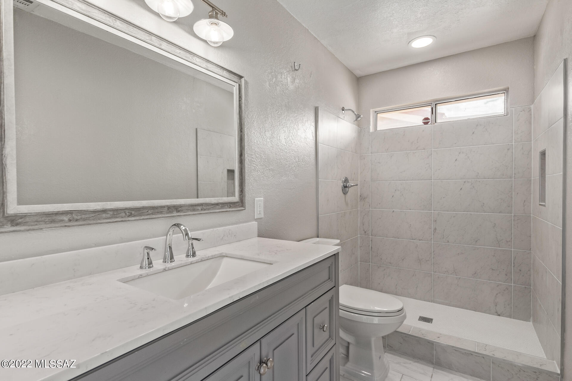 4697 West Weathervane Street Tucson, AZ 85741 - Photo 20 of 25 a bathroom with a sink a toilet and shower
